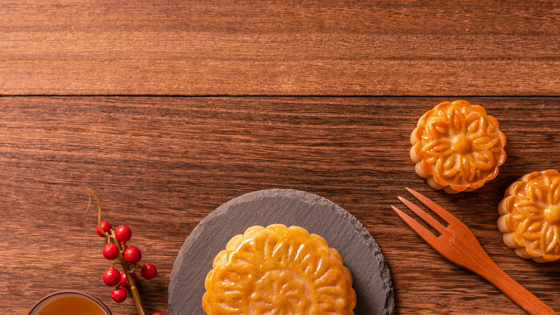 Traditional baked mooncakes on wooden table, showcasing Gin Thye’s heritage and craftsmanship since 1964