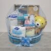 Blue baby hamper from Gin Thye featuring Muji baby gift set, Johnson & Johnson products, and baby essentials in a yellow oval basket